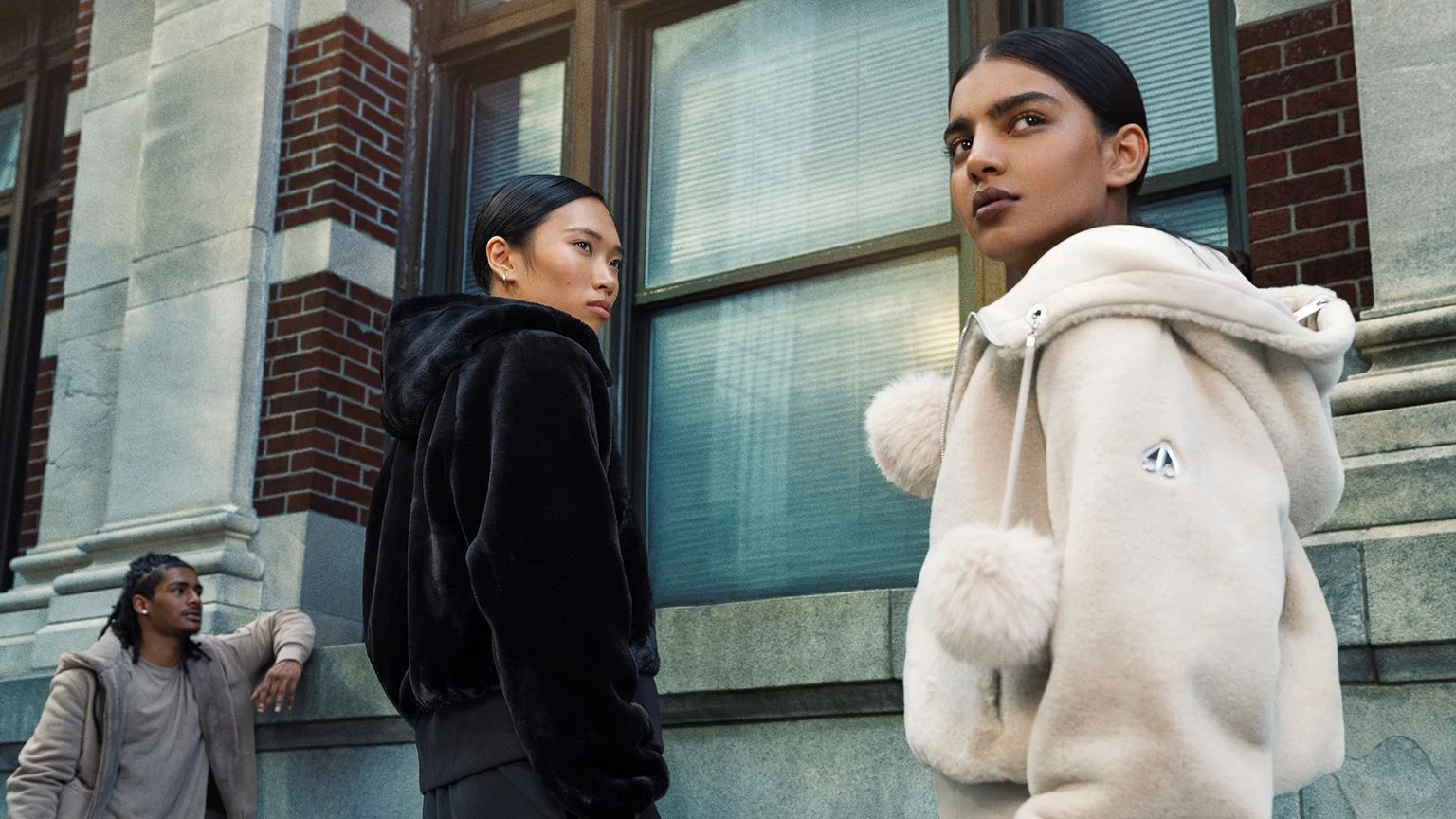 Models showcasing black outerwear and tailored pants from the WARDROBE.NYC x H&M collection.